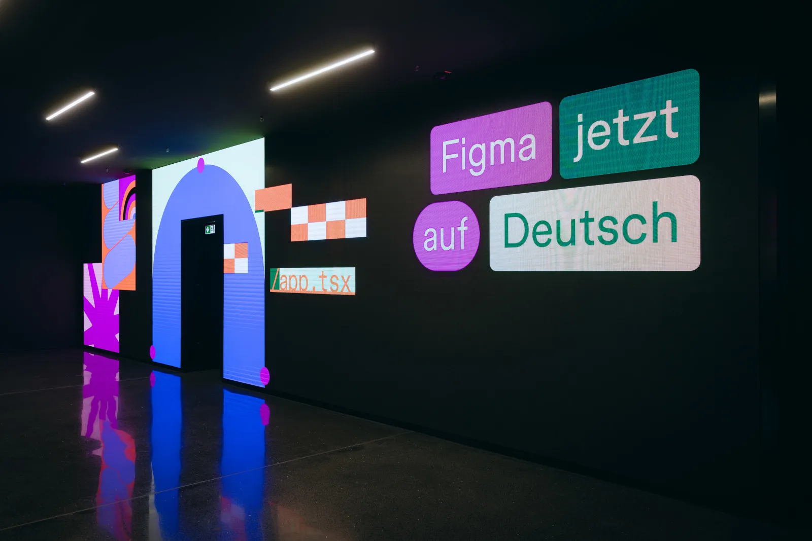 Leuchtende Wandinstallation mit Schriftzug ‚Figma jetzt auf Deutsch‘ - visuelles Branding während des Maker Collective Events in Düsseldorf.
